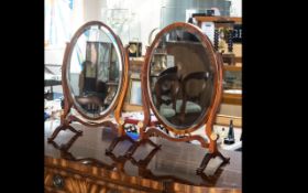 A Pair Of 19th Century Toilette Mirrors oval mirror with bevelled glass on turned supports with