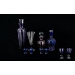 A Collection of Mauve and Blue Decorative Glassware to include a tall mauve glass decanter with