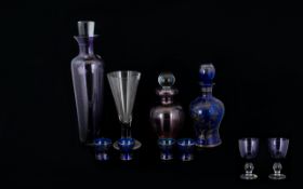 A Collection of Mauve and Blue Decorative Glassware to include a tall mauve glass decanter with