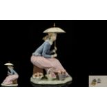 Nao by Lladro Handpainted Porcelain Figure 'Girl with Parasol' seated with baskets of flowers to