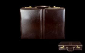 Leather Briefcase Of typical form with gold hardware and combination lock,
