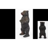 A Cast Metal Standing Bear Money Box cast in two pieces, textured finish, height, 6 1/2 inches.