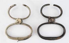 A Pair Of Antique Metal Shackles One With Aged Patina. Both Of Typical Form. Please See Image.