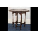 A Carved Oak Drop Leaf Gate Leg Table carved top, turned support.