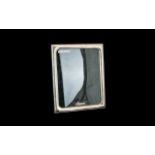 A Boxed Irish Silver Picture Frame By Celtic Frames Of square form with velvet lined back and strut.