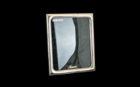 A Boxed Irish Silver Picture Frame By Celtic Frames Of square form with velvet lined back and strut.