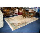 A Large Oriental Wool Rug Cream ground with triple border detail in foliate and Greek key