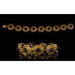 9ct Gold And Amethyst Fancy Link Bracelet Comprising bauble panel links each set with amethyst