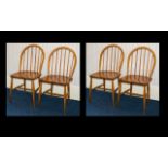 Ercol Four Mid Century Windsor Dining Chairs Of typical form, each with impressed mark to underside,
