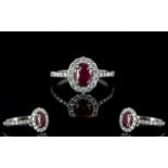 18ct White Gold Ruby And Diamond Cluster Ring Central ruby surrounded by round modern brilliant