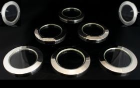 A Set Of Thirteen Silver Plated Wine Coasters Circular form with glass insert,