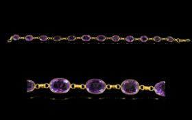 A 14ct Gold And Amethyst Set Bracelet Elegant yellow gold bracelet set with twelve faceted