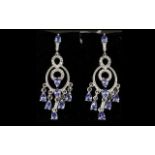 Tanzanite and Zircon Chandelier Earrings, each earring having a fringe of pear cut tanzanites on a