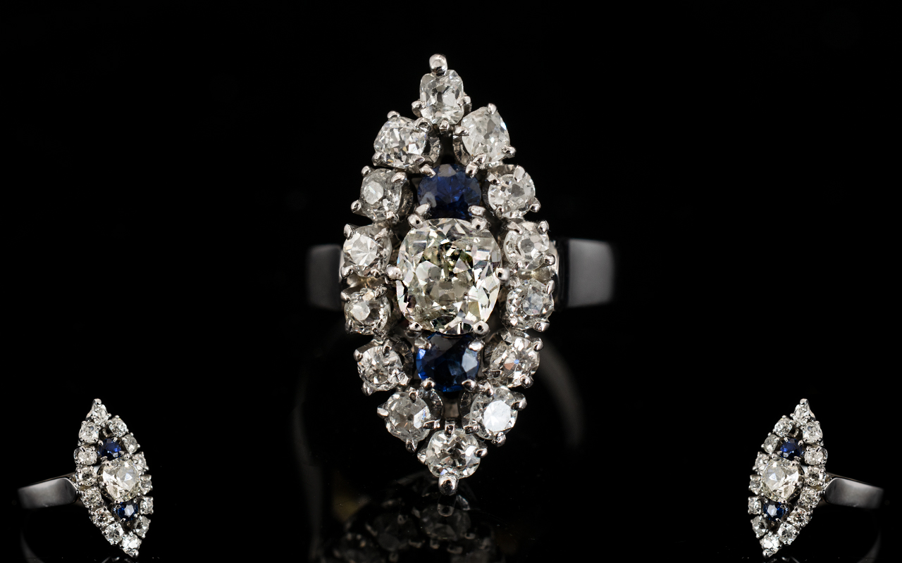 18ct White Gold Marquis Shaped Diamond Cluster Ring The central cushion curt diamond between two