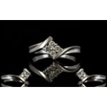 9ct White Gold Diamond Ring Set with four round brilliant cut diamonds on a twist, fully hallmarked,