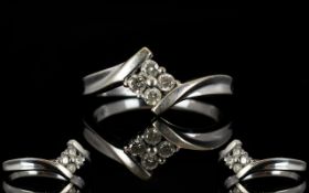 9ct White Gold Diamond Ring Set with four round brilliant cut diamonds on a twist, fully hallmarked,