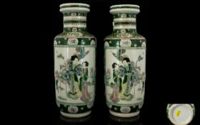 A Pair Of Famille Vert Vases Each with vignettes to body depicting figures and infants in garden