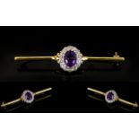 18ct Gold Diamond Bar Brooch The central oval amethyst surrounded by round cut diamonds,