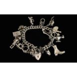 A Silver Curb Bracelet Loaded with 14 Solid Silver Old Charms From The 1950's / 1960's.