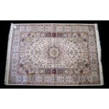 A Large Woven Silk Carpet Keshan rug with beige ground and traditional Middle Eastern floral and