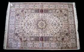 A Large Woven Silk Carpet Keshan rug with beige ground and traditional Middle Eastern floral and