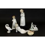 A Collection Of Four Nao And One LLadro FigureS to include girl with doll, girl with ragdoll, girl