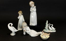 A Collection Of Four Nao And One LLadro FigureS to include girl with doll, girl with ragdoll, girl