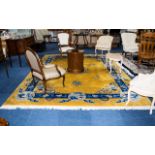 A Very Large Oriental Wool Rug Ochre ground with cobalt and sky blue borders and taupe/cream