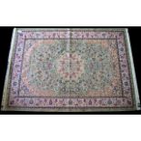 A Large Woven Silk Carpet Keshan rug with eau de nil ground and traditional Middle Eastern floral