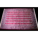 A Large Woven Silk Bokhara Carpet Ornate