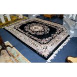 A Very Large Oriental Wool Carpet Rectangular rug with black ground,