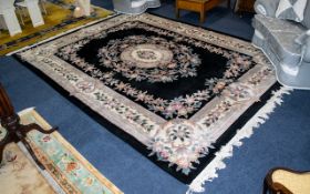 A Very Large Oriental Wool Carpet Rectangular rug with black ground,