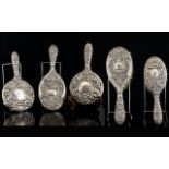 Embossed Silver Backed Vanity Items Five pieces in total, to include mirrors and brush two