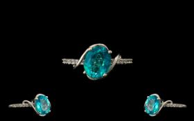Paraiba Topaz Solitaire Style Ring, an oval cut paraiba topaz solitaire of 3.