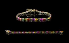 Multi Colours of Sapphire Tennis Bracelet, a continuous row of oval cut green, yellow, orange,