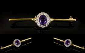 18ct Gold Diamond Bar Brooch The central oval amethyst surrounded by round cut diamonds, stamped