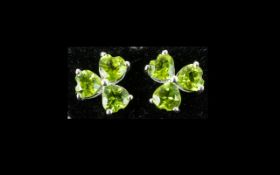 Peridot Pair of Three Stone Earrings, three heart cut peridots set point to point in each earring,