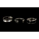 Three Silver Modernist Style Bangles Each marked for silver, comprising wide open buckle style cuff,