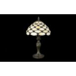 A Reproduction Tiffany Style Table Lamp Raised on a art nouveau style cast metal base,