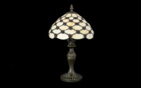 A Reproduction Tiffany Style Table Lamp Raised on a art nouveau style cast metal base,