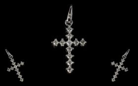 A 9ct White Gold Diamond Cross Set with 11 round brilliant cut diamonds, stamped 375, approx 25 mm.