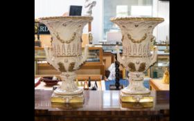 P Weldon A Pair of Staffordshire Cream Glazed Campana Urns - floor standing, raised on square base