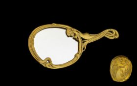 Art Nouveau Style Brass Hand Mirror Of oval form in embossed sinuous brass whiplash frame with