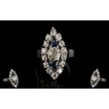 18ct White Gold Marquise Shaped Diamond Cluster Ring The central cushion cut diamond between two