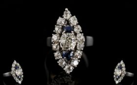 18ct White Gold Marquise Shaped Diamond Cluster Ring The central cushion cut diamond between two