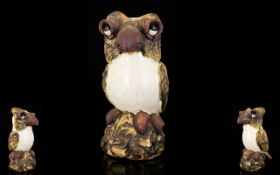 An Earthenware Figure In The Form Of A Grotesque Bird Raised on circular ceramic base, unmarked,