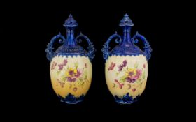 A Pair Of Late 19th/Early 20th Century Lidded Urns Each of ovoid form with moulded twin scroll