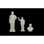 A Collection Of Three Chairman Mao Figures To include two porcelain and one bisque figure,