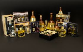 A Mixed Collection Of Whisky Gift Packs And Commemorative Bottles To include four empty collectable