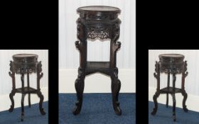 A Chinese Wooden Jardiniere Stand - of circular form with carved, pierced floral decoration,